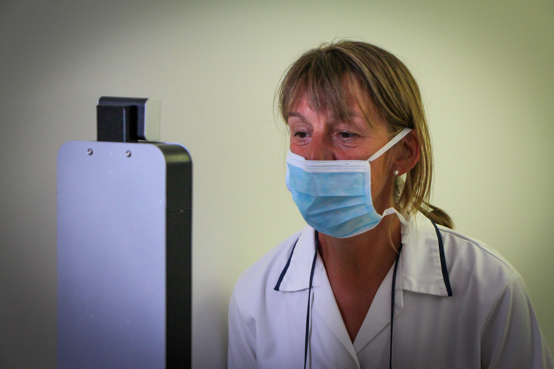 body temperature scan at a care home, wearing a mask, mask detection, temperature testing machine